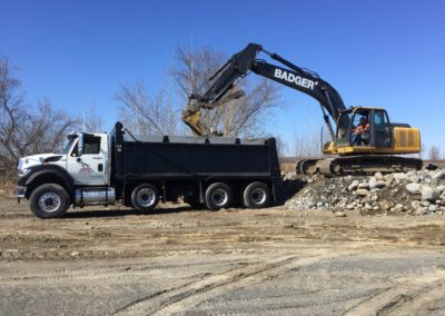 Moving fill with hy-hoe and dump truck