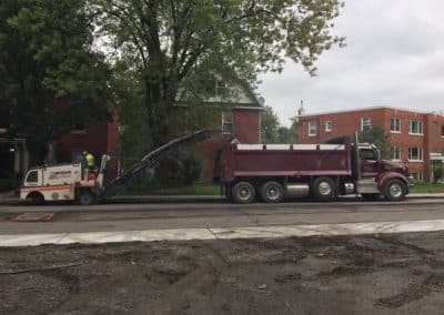 Asphalt grinder loading dump truck